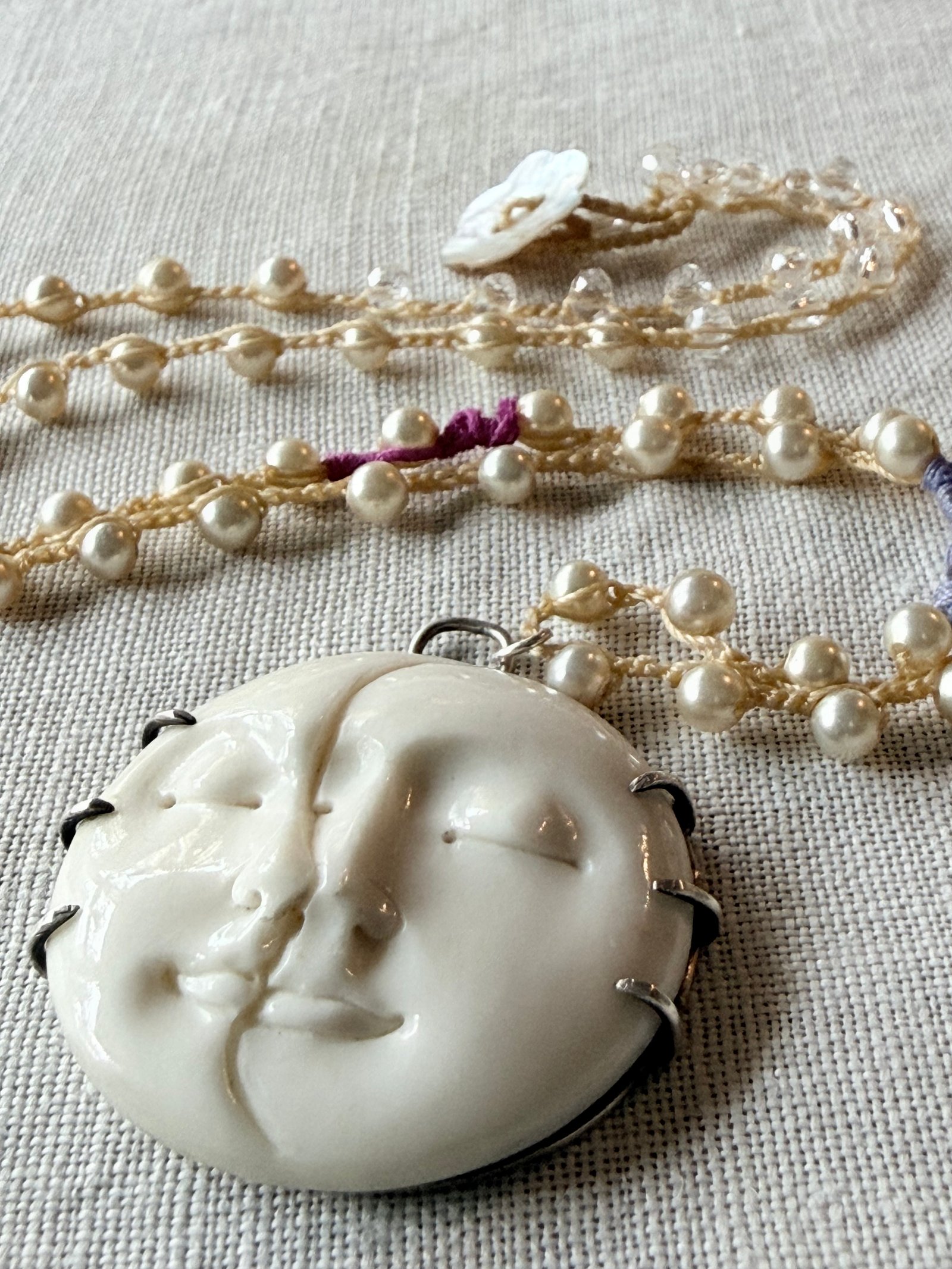 White relief pendant and freshwater pearl hand-crocheted necklace