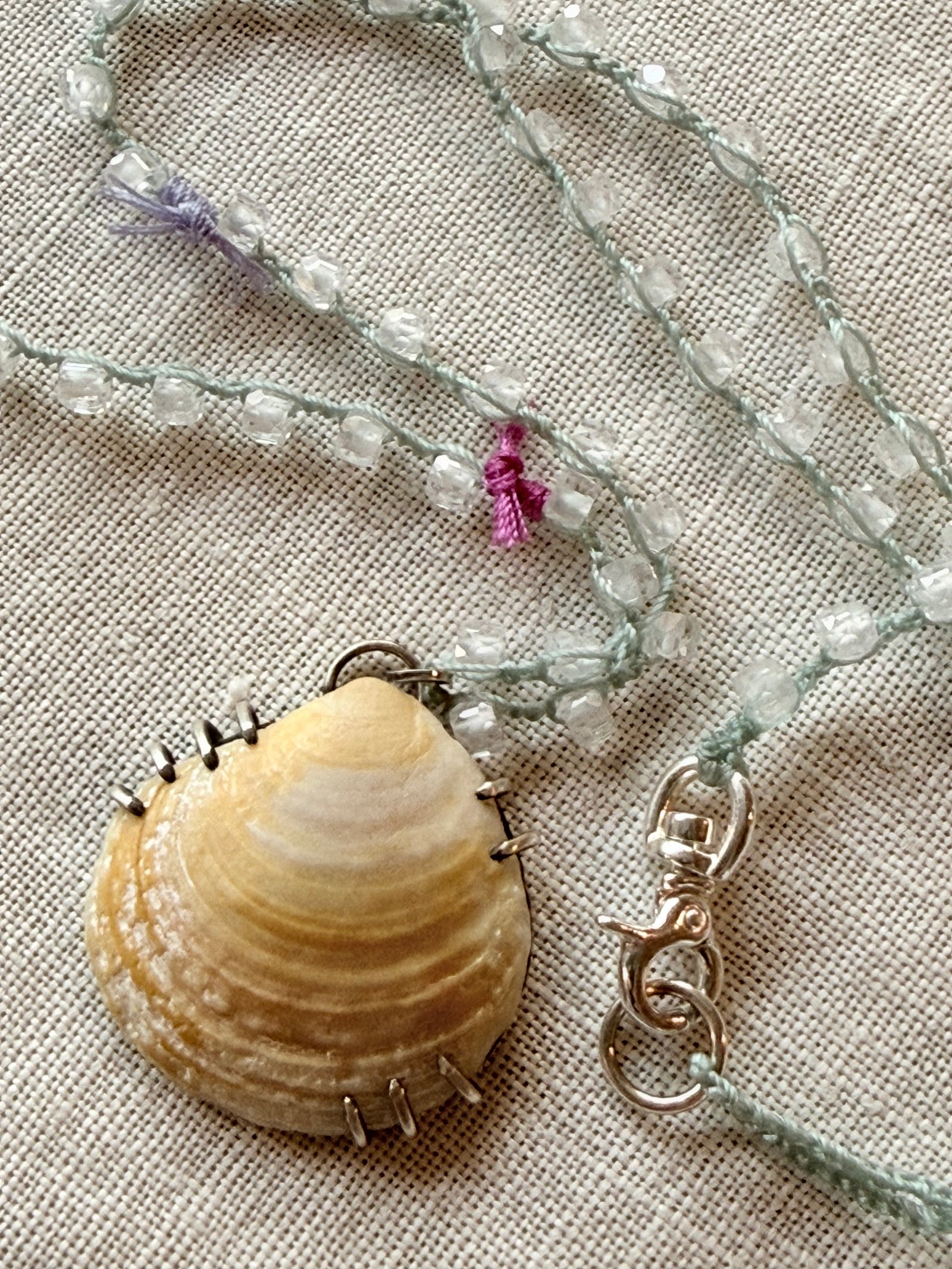 Golden shell pendant and clear gemstone seafoam crochet necklace