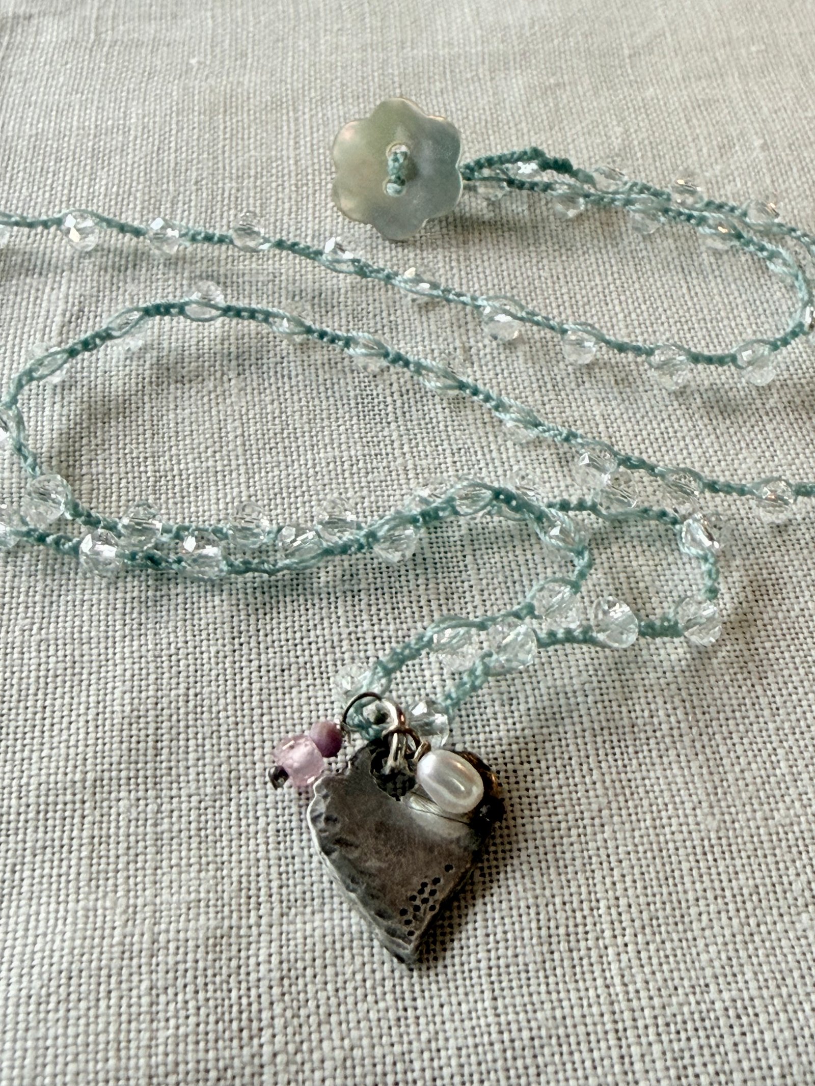 Seafoam crochet necklace with a rustic silver heart and natural gemstones