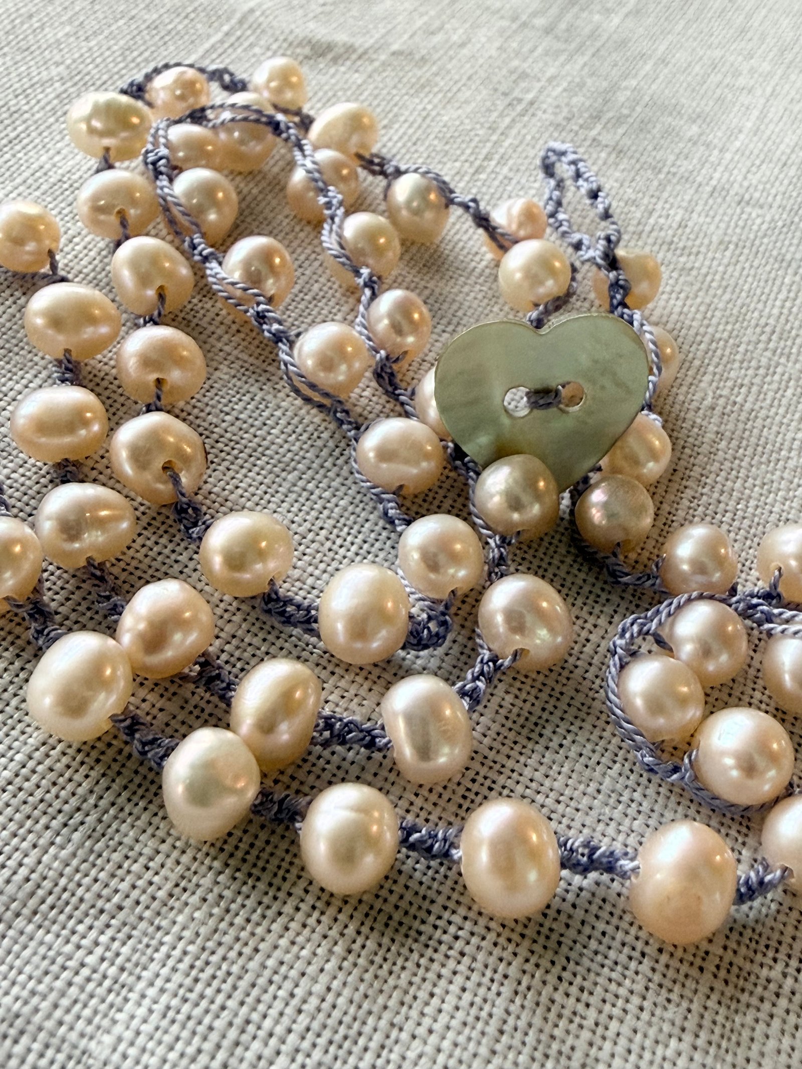Freshwater pearl crochet necklace with an iridescent heart-shaped closure
